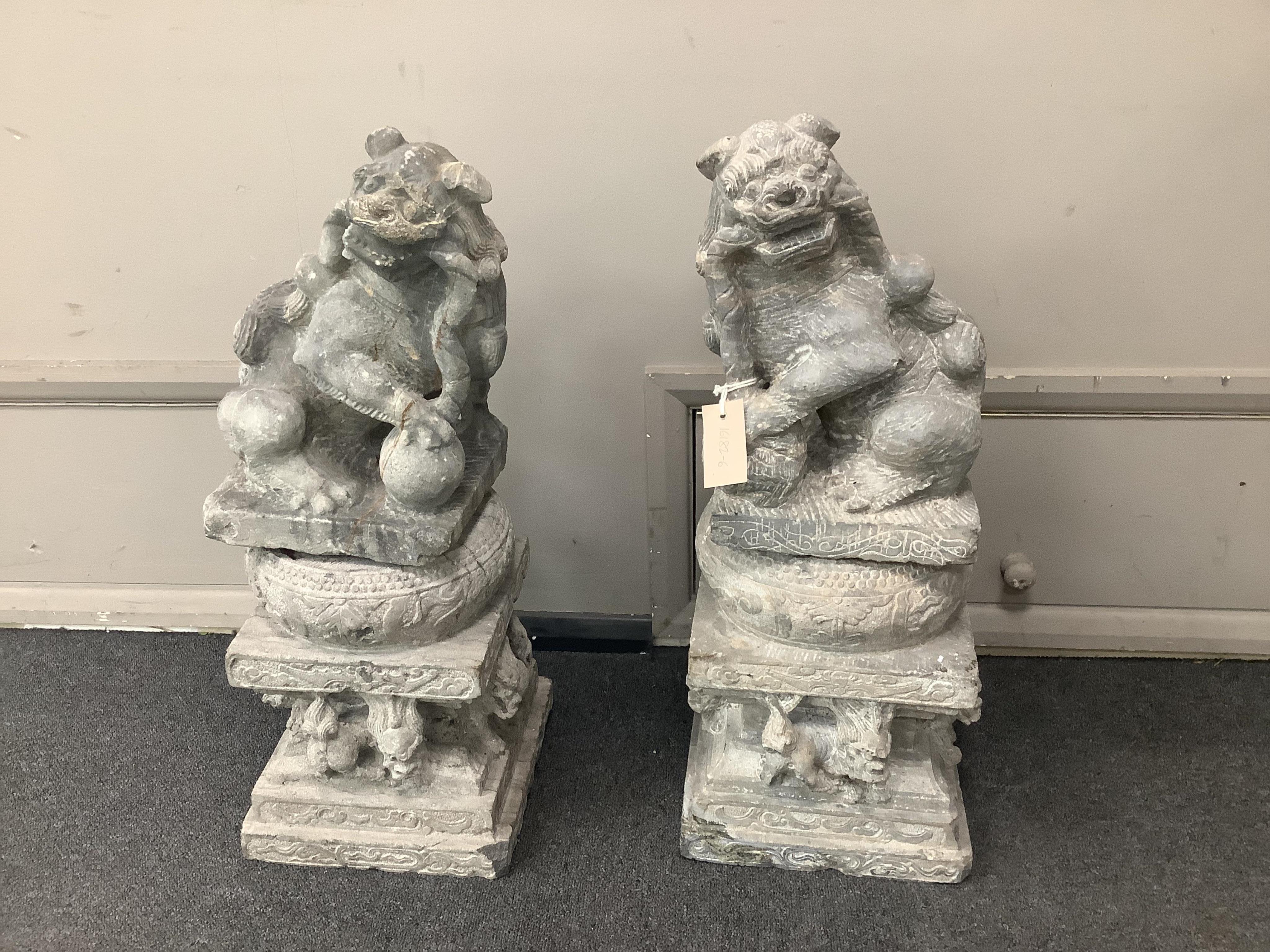 A pair of Chinese limestone supports for columns and a pair of Chinese limestone figures of Buddhistic lions Qing dynasty, 66cm high. Condition - fair